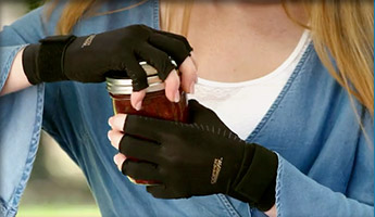 Wearing Copper Fit® Hand Relief at work on the phone